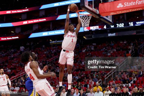 Amen Thompson of the Houston Rockets dunks the ball in the first half against the Golden State Warriors at Toyota Center on April 04, 2024 in...