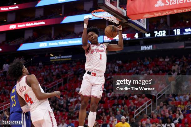 Amen Thompson of the Houston Rockets dunks the ball in the first half against the Golden State Warriors at Toyota Center on April 04, 2024 in...