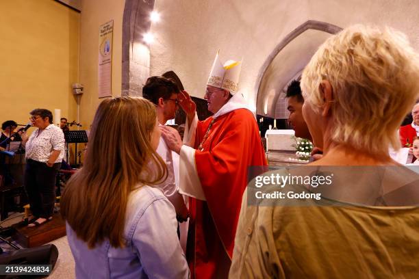 Saint Nicolas church. Catholic mass. Adult confirmation ceremony. France.