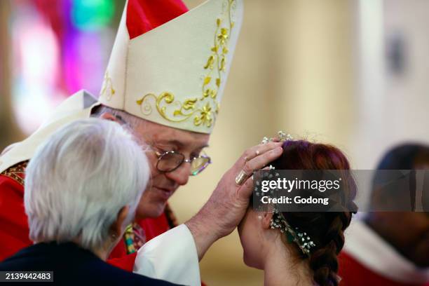 St Francis de Sales basilica. Catholic mass. Adult confirmation ceremony. Bishop wearing white miter. France.