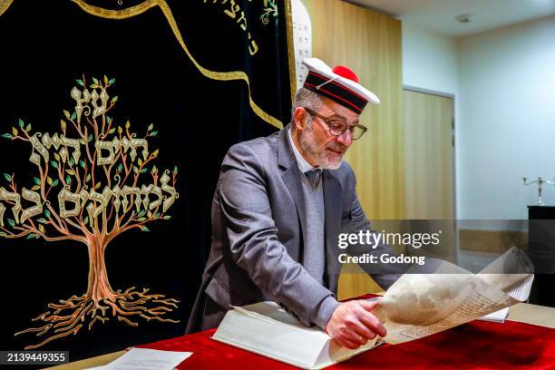 Purim celebration in Beth Yaacov synagogue, Paris, France. Rabbi Gabriel Farhi reading Esther's scroll.