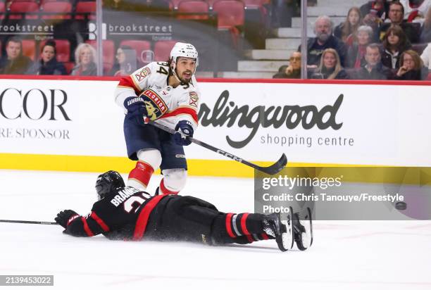 Ryan Lomberg of the Florida Panthers shoots the puck past a diving Erik Brannstrom of the Ottawa Senators during the third period at Canadian Tire...