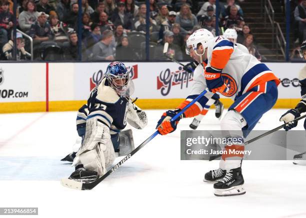 Jet Greaves of the Columbus Blue Jackets defends against Kyle Palmieri of the New York Islanders during the third period at Nationwide Arena on April...