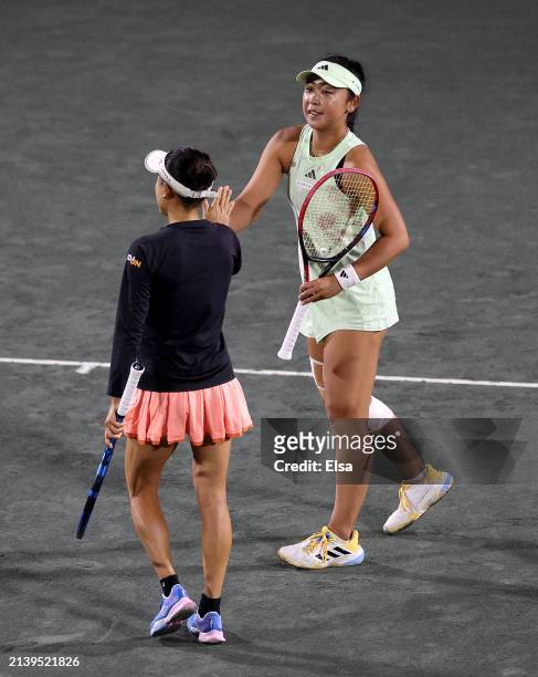 Eri Hozumi of Japan and teammate Makoto Ninomiya of Japan celebrate a pointduring their doubles match against Hao-Ching Chan of Taipei and Veronika...