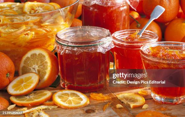 Agriculture - Still life of jars of marmalade made from Seville oranges, with the ingredients in the background, studio.