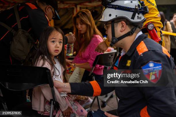 Child is given medical care at a temporary rescue command post outside of the Taroko Gorge after being rescued on April 05, 2024 in Hualien, Taiwan....