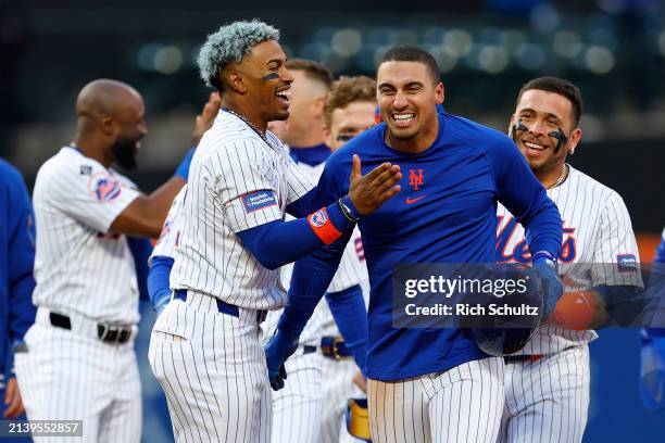 Tyrone Taylor of the New York Mets is hugged by Francisco Lindor after he hit a walk off RBI single in the ninth inning defeating the Detroit Tigers...