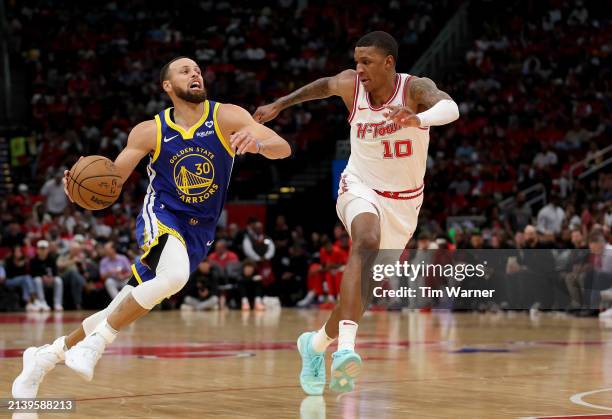 Stephen Curry of the Golden State Warriors drives to the basket against Jabari Smith Jr. #10 of the Houston Rockets in the second half at Toyota...