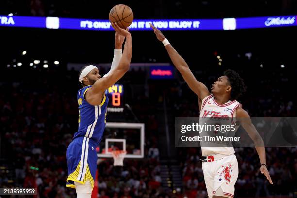 Moses Moody of the Golden State Warriors shoots the ball against Amen Thompson of the Houston Rockets in the second half at Toyota Center on April...