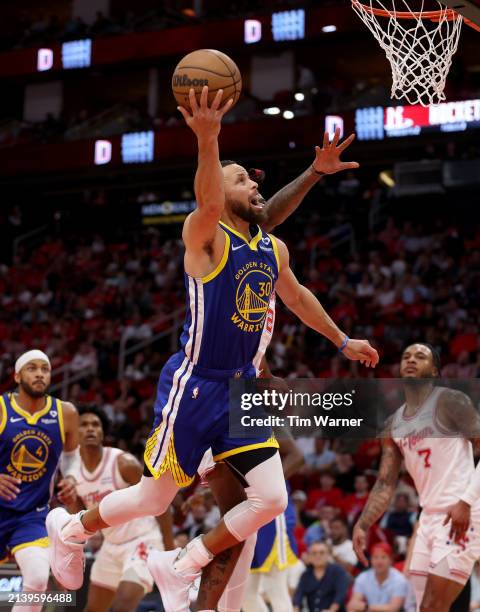 Stephen Curry of the Golden State Warriors goes for a lay up against the Houston Rockets in the second half at Toyota Center on April 04, 2024 in...