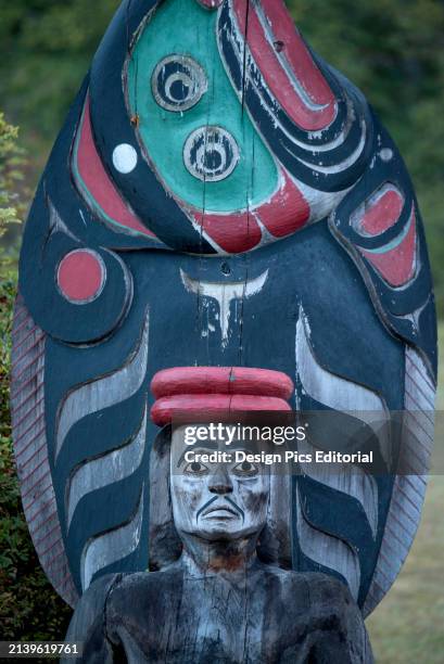 Totem pole in a cemetery on Cormorant Island near Vancouver Island, Haida Gwaii, BC, Canada. Cormorant Island, Haida Gwaii, British Columbia, Canada.
