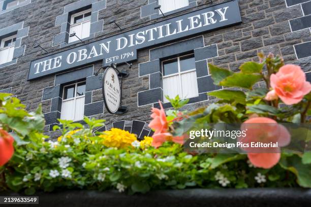 Flowers bloom outside the Oban Distillery in Scotland. Oban, Scotland.