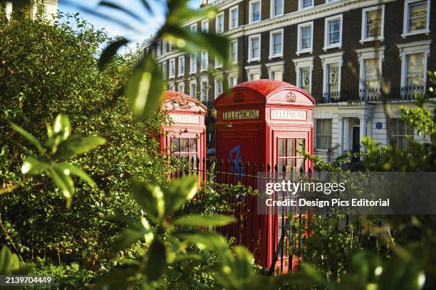 Red Telephone Booths In Primrose Hill. London, England.