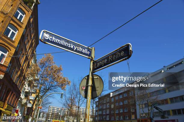 Street Signs at An Intersection With Buildings and Blue Sky. Hamburg, Germany.