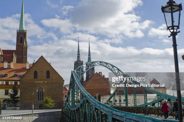 Tumski Bridge And Lovers Locks With Spires of Cathedral In The Background. Wroclaw, Lower Silesia, Poland.