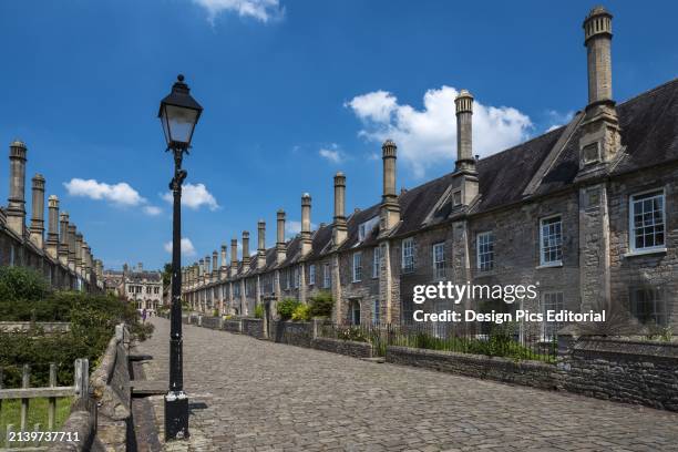 Historic houses on Vicars' Close with a street lamp and cobblestone street. Built between 1348 and 1430, Vicars' Close is claimed to be the oldest...