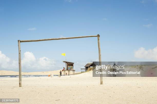 Wooden Goal Post on The Beach With A Lifeguard on Duty In The Background. Valizas, Uruguay.