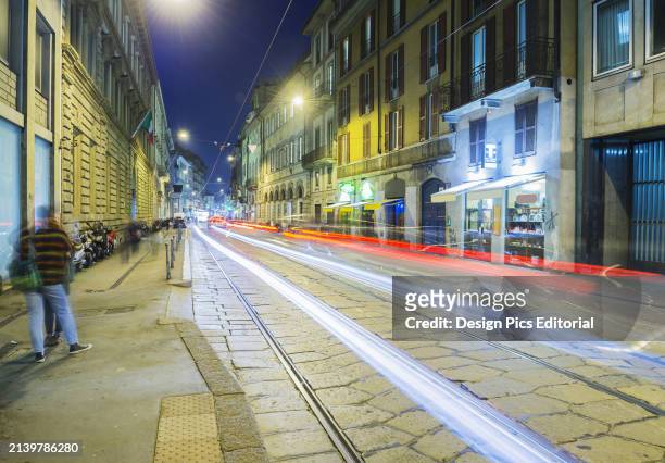 Light Trails of Headlights and Taillights Down A Street. Milan, Lombardy, Italy.