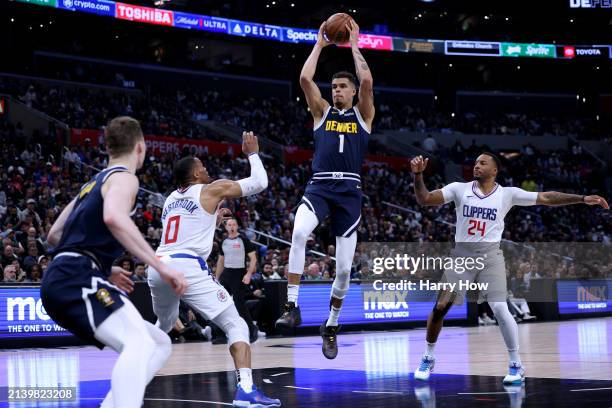 Michael Porter Jr. #1 of the Denver Nuggets catches a pass between Norman Powell and Russell Westbrook of the LA Clippers during a 102-100 Clippers...