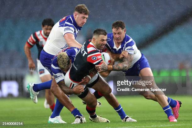 James Tedesco of the Roosters is tackled during the round five NRL match between Canterbury Bulldogs and Sydney Roosters at Accor Stadium on April 05...