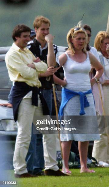 British Prince William watches the match with unidentified girl at Beaufort polo club on July 6, 2003 in Tetbury, England.