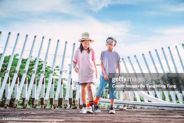 togetherness on the trail: sibling bonding in play - hong kong racing stock pictures, royalty-free photos & images