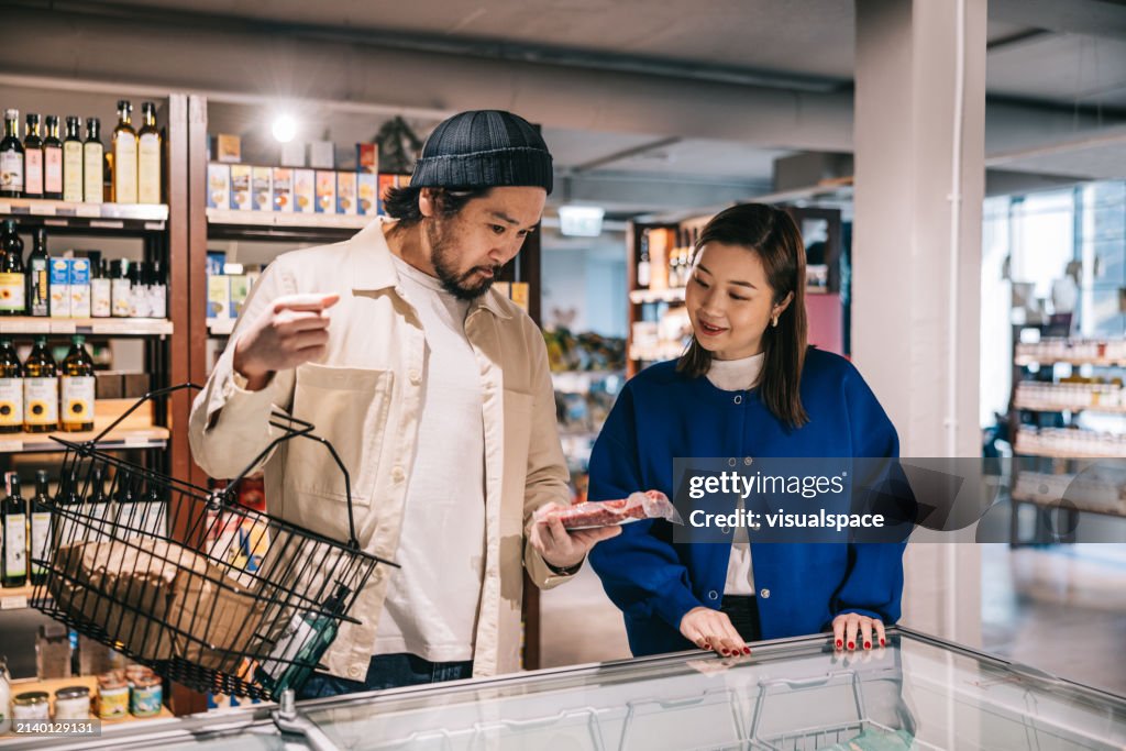 Japanese couple browses frozen items at the organic convenience store
