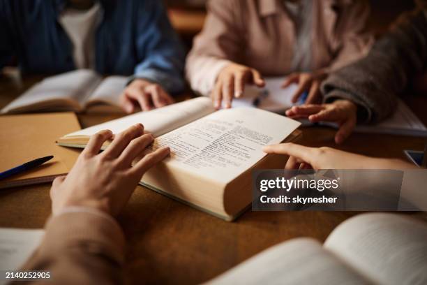 close up of unrecognizable students going through dictionary. - woordenboek stockfoto's en -beelden