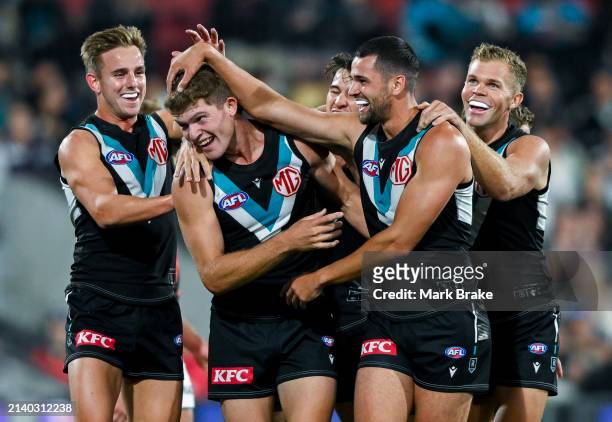 Mitch Georgiades of the Power celebrates a goal with Ryan Burton and Dan Houston of the Power during the round four AFL match between Port Adelaide...