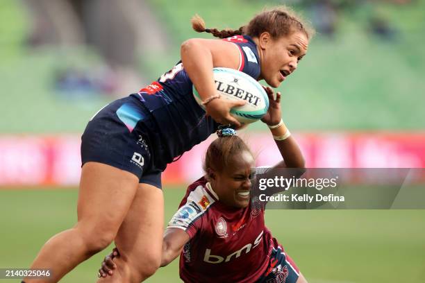 Ashley Marsters of the Rebels is tackled by Ivania Wong of the Reds during the round four Super Rugby Women's match between Melbourne Rebels and...