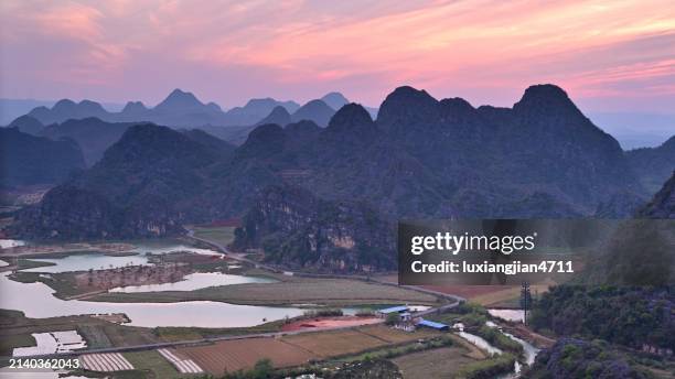 sunset clouds in rural karst landscape - shadowgraph stock pictures, royalty-free photos & images