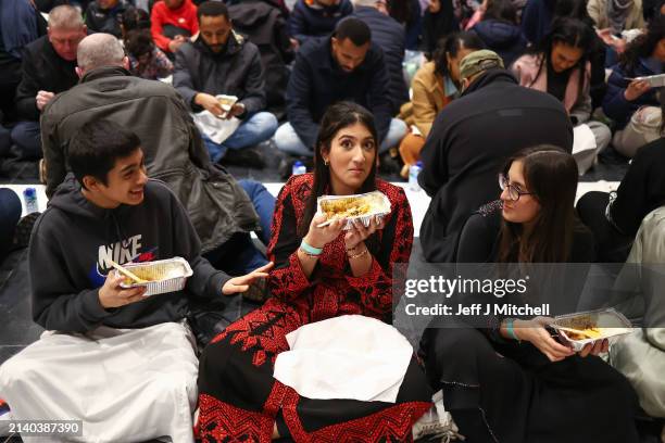 Members of the public have a communal meal at an Iftar event in the V&A museum on April 04, 2024 in Dundee, Scotland. Open Iftar is organised by the...