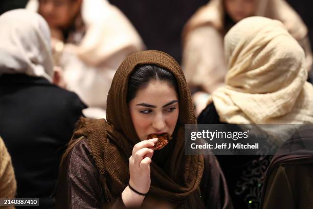 Members of the public break their fast ahead of the call to prayer at an Iftar event in the V&A museum on April 04, 2024 in Dundee, Scotland. Open...