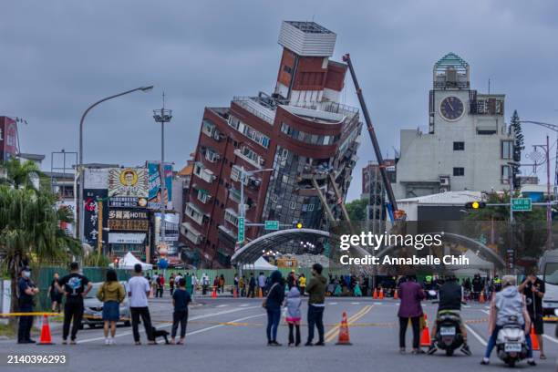 People come to watch the collapsed building on the street on April 05, 2024 in Hualien, Taiwan. There are still hundreds of victims stuck in the...