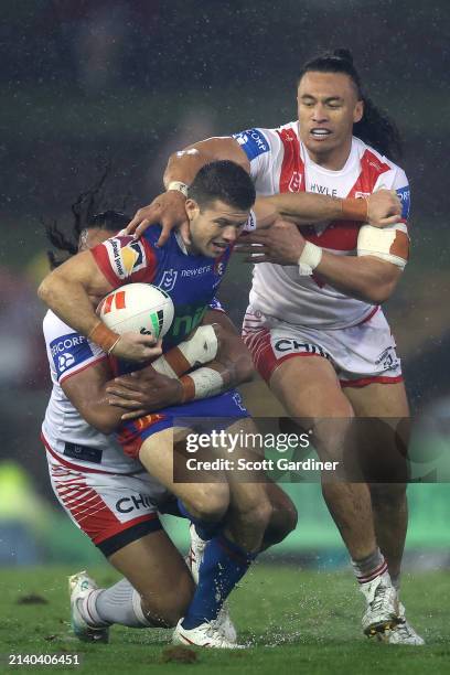 Jack Cogger of the Knights is tackled during the round five NRL match between Newcastle Knights and St George Illawarra Dragons at McDonald Jones...