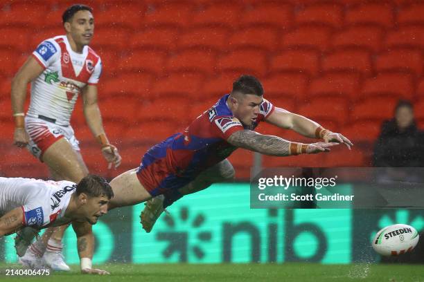 Bradman Best of the Knights attempts to score a try during the round five NRL match between Newcastle Knights and St George Illawarra Dragons at...