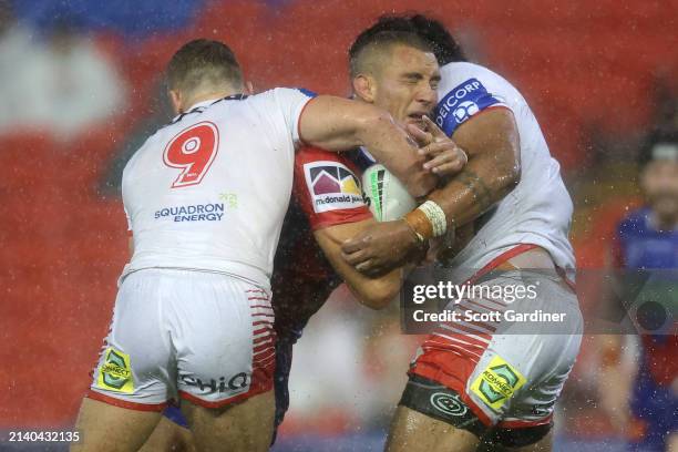 Mathew Croker of the Knights is tackled during the round five NRL match between Newcastle Knights and St George Illawarra Dragons at McDonald Jones...