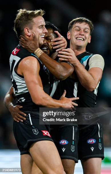 Willie Rioli of the Power celebrates a goal with Jackson Mead and Zak Butters of the Power during the round four AFL match between Port Adelaide...