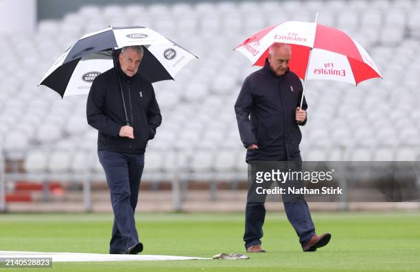 Match Umpires Peter Hartley and Paul Pollard inspect the pitch as play is cancelled during Vitality County Championship between Lancashire and Surrey...