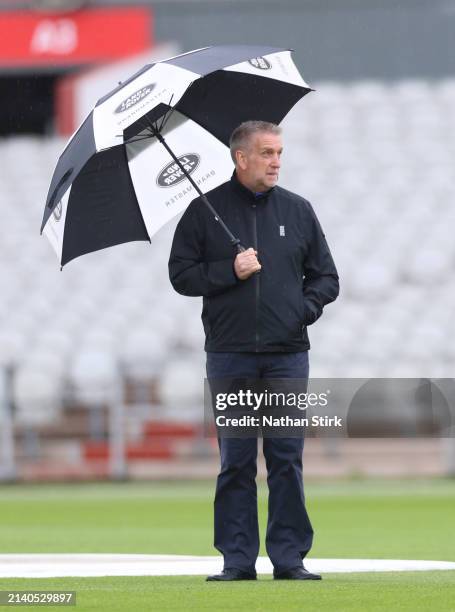 Match Umpire Paul Pollard inspects the pitch as play is cancelled during Vitality County Championship between Lancashire and Surrey at Emirates Old...