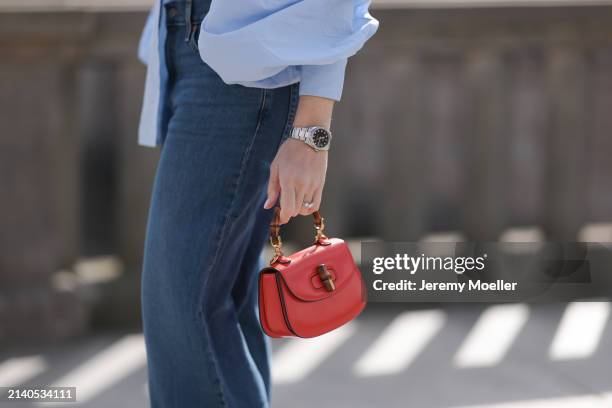 Sonia Lyson seen wearing SoSue light blue cotton buttoned oversized shirt, Levi’s dark blue denim straight leg long pants, Gucci bamboo red / orange...