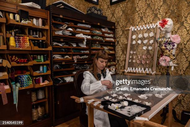 Seamstress of the Italian fashion house Dolce & Gabbana works on haute couture outfits during the exhibition "From the Heart to the Hands: Dolce &...