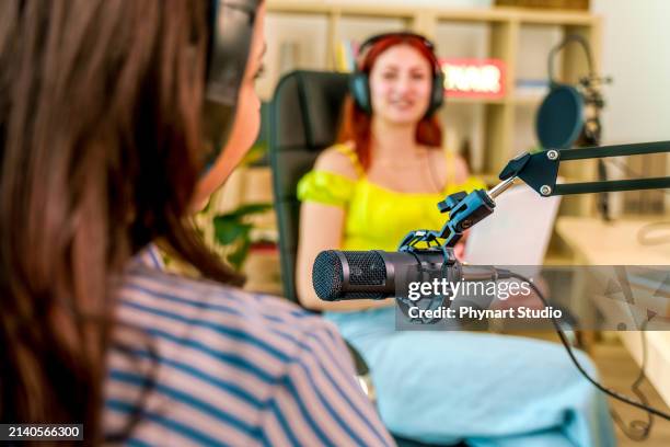 two young people recording a podcast - locutor-de-rádio imagens e fotografias de stock