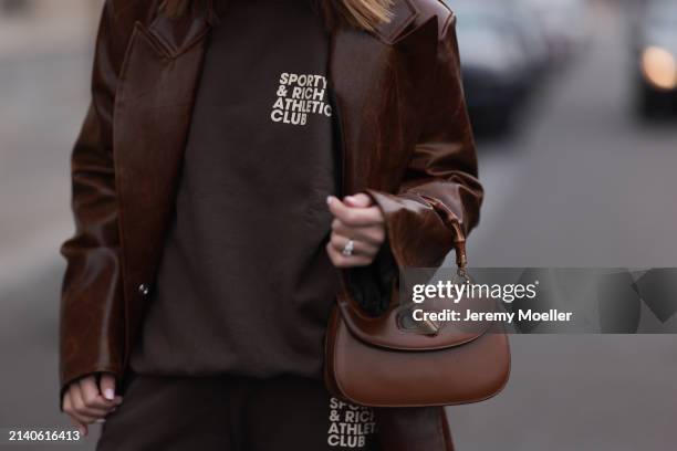 Sonia Lyson seen wearing Sporty & Rich brown cotton oversized logo sweater, matching Sporty & Rich brown cotton jogger pants, Milk White brown...