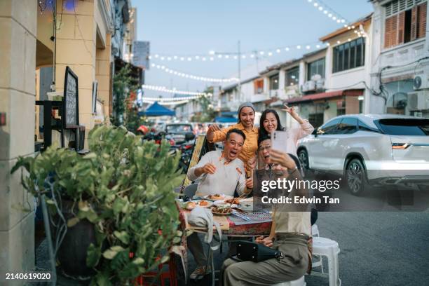 group of asian senior tourist selfie with local tour guide enjoying local food in penang island old town - penang state stock pictures, royalty-free photos & images