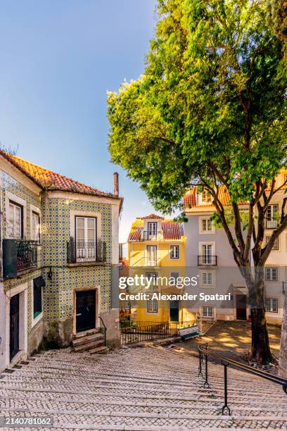 alleys of alfama district on a sunny day, lisbon, portugal - lissabon stockfoto's en -beelden