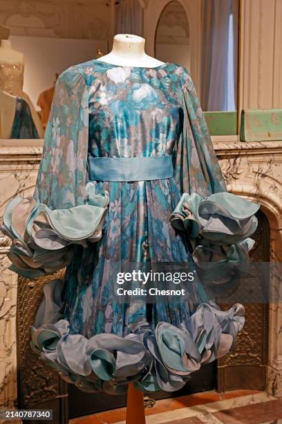 Creation by designer Roberto Capucci, Alta Moda collection, circa 1980, short evening dress in silk rep and blue floral silk chiffon is displayed...