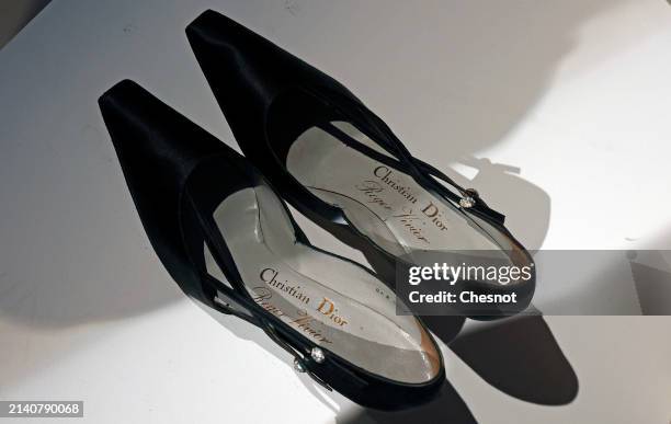 Creation by designer Roger Vivier, for Christian Dior circa 1958, pair of evening pumps. In black satin silk. Is displayed during "Un siècle de Haute...