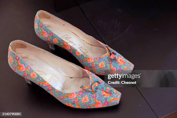Creation by designer Roger Vivier, circa 1960, pair of pumps covered with printed silk reps is displayed during "Un siècle de Haute Couture"...
