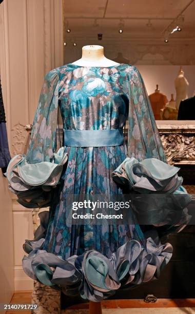 Creation by designer Roberto Capucci, Alta Moda collection, circa 1980, short evening dress in silk rep and blue floral silk chiffon is displayed...